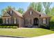 Charming brick home boasts a manicured lawn, beautiful landscaping, and inviting curb appeal at 3053 Lawson Dr, Marietta, GA 30064
