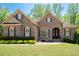 Charming brick home boasts a manicured lawn, beautiful landscaping, and inviting curb appeal at 3053 Lawson Dr, Marietta, GA 30064