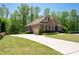 Elegant brick home with a long driveway and attached garage in a lush, green setting at 3053 Lawson Dr, Marietta, GA 30064
