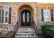 Arched, double front door, brick facade, and stone steps add character to this home's entrance at 3053 Lawson Dr, Marietta, GA 30064