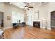 Bright living room features hardwood floors, fireplace, built-in shelving, and large windows with shutters at 3053 Lawson Dr, Marietta, GA 30064