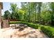Stone patio with outdoor seating and lush landscaping, perfect for entertaining at 3053 Lawson Dr, Marietta, GA 30064