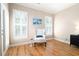 Bedroom sitting area features a comfortable armchair, windows with shutters, and hardwood floors at 3053 Lawson Dr, Marietta, GA 30064