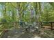 Relax on the wooden back deck, complete with outdoor seating, perfect for grilling and entertaining in a wooded setting at 3139 Mary Dr, Marietta, GA 30066