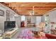 Finished basement with exposed ceiling, TV, seating area, and exterior access at 3139 Mary Dr, Marietta, GA 30066