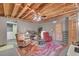 Finished basement featuring exposed ceiling, red accent chairs and seating area at 3139 Mary Dr, Marietta, GA 30066