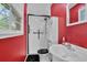 Bathroom with modern shower, red accent wall, and natural light at 3139 Mary Dr, Marietta, GA 30066