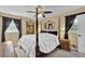 Traditional bedroom with four-poster bed, ceiling fan, and decorative mirror at 3139 Mary Dr, Marietta, GA 30066