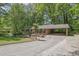 Traditional brick home with a convenient carport and well-manicured lawn in a serene, wooded setting at 3139 Mary Dr, Marietta, GA 30066