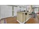 Bright eat-in kitchen features white cabinets, bar seating, and stainless steel appliances at 3139 Mary Dr, Marietta, GA 30066
