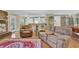 Comfortable living room featuring recliner sofa, arm chair, hardwood floors, and brick fireplace at 3139 Mary Dr, Marietta, GA 30066