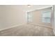 Empty bedroom with neutral carpet and lots of natural light from two windows at 3699 School Street, Chamblee, GA 30341