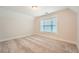 Bright carpeted bedroom offers a serene setting with neutral colors and a large window at 3699 School Street, Chamblee, GA 30341