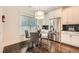 Bright breakfast nook featuring hardwood floors, modern lighting, stainless appliances and a large window at 3699 School Street, Chamblee, GA 30341
