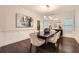 Elegant dining room with modern lighting, wainscoting, and hardwood floors at 3699 School Street, Chamblee, GA 30341
