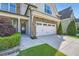 Attractive home exterior featuring stone accents, a two-car garage, and a charming front entrance at 3699 School Street, Chamblee, GA 30341