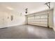 Clean, well-lit two car garage with epoxy flooring, storage, and automatic door at 3699 School Street, Chamblee, GA 30341