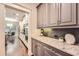 Kitchen view showing stainless steel appliances, gray cabinets, granite countertops, and hardwood floors at 3699 School Street, Chamblee, GA 30341