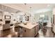 Open-concept kitchen with a large island, stainless appliances, and seamless flow to the living room at 3699 School Street, Chamblee, GA 30341
