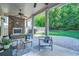 Inviting covered patio with a stone fireplace and comfortable seating overlooking the landscaped backyard at 3699 School Street, Chamblee, GA 30341