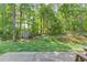 Beautiful backyard features a shed, lush greenery, and a picnic table at 3987 Ivory Gables Pl, Buford, GA 30519
