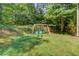 Backyard with play set and lush lawn at 3987 Ivory Gables Pl, Buford, GA 30519