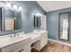 Bathroom features a double sink vanity, framed mirrors, and a separate shower at 3987 Ivory Gables Pl, Buford, GA 30519