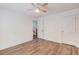Bright bedroom features hardwood flooring, a ceiling fan, and neutral walls at 3987 Ivory Gables Pl, Buford, GA 30519