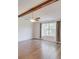 Bright bedroom featuring hardwood floors, beamed ceilings, and natural light at 3987 Ivory Gables Pl, Buford, GA 30519