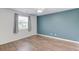 Bedroom with hardwood floors, a ceiling fan, and an accent wall at 3987 Ivory Gables Pl, Buford, GA 30519