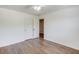 Bright bedroom featuring hardwood floors, white walls, ceiling fan, and two door closets at 3987 Ivory Gables Pl, Buford, GA 30519