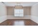 Bright dining room with hardwood floors, modern lighting, and window that allows plenty of natural light at 3987 Ivory Gables Pl, Buford, GA 30519