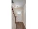 Inviting entryway featuring hardwood floors, a white front door and staircase with wooden accents at 3987 Ivory Gables Pl, Buford, GA 30519