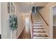 Bright entryway with hardwood floors, staircase, and stylish lighting, creating a welcoming ambiance at 3987 Ivory Gables Pl, Buford, GA 30519
