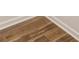 Close-up on rich, dark herringbone-patterned wood flooring and crisp white trim at 3987 Ivory Gables Pl, Buford, GA 30519