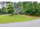 Inviting two-story home with lush green lawn and mature trees enhancing its curb appeal in a tranquil setting at 3987 Ivory Gables Pl, Buford, GA 30519