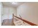 Upstairs hallway with hardwood floors and white doors leading to bedrooms and bathrooms at 3987 Ivory Gables Pl, Buford, GA 30519