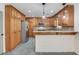 Well-lit kitchen with wooden cabinets, granite countertops, stainless steel appliances, and tile floor at 3987 Ivory Gables Pl, Buford, GA 30519
