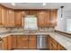 Charming kitchen features granite countertops, stainless appliances, and ample cabinet storage at 3987 Ivory Gables Pl, Buford, GA 30519