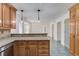 Open kitchen offers granite countertops, stainless appliances, tile floors and lots of cabinet space at 3987 Ivory Gables Pl, Buford, GA 30519