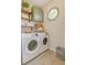 Organized laundry room with modern appliances, shelving, and stylish decor at 3987 Ivory Gables Pl, Buford, GA 30519