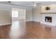 Spacious living room with hardwood floors, a decorative ceiling fan, and a cozy fireplace at 3987 Ivory Gables Pl, Buford, GA 30519