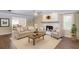 Inviting living room with fireplace, hardwood floors and neutral colors at 3987 Ivory Gables Pl, Buford, GA 30519