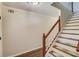 Bright staircase features hardwood floors and a classic white wood banister with carpeted treads at 3987 Ivory Gables Pl, Buford, GA 30519