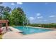 A community swimming pool with a pergola and lounge chairs at 3987 Ivory Gables Pl, Buford, GA 30519
