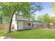 The exterior features a covered patio, a well-manicured lawn, and a privacy fence at 6891 Hickory Log Rd, Austell, GA 30168
