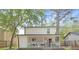Backyard view featuring a covered patio, green lawn, and privacy fence at 6891 Hickory Log Rd, Austell, GA 30168