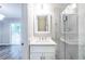 Bright bathroom featuring marble tile shower, white vanity and quartz countertop at 6891 Hickory Log Rd, Austell, GA 30168