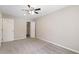 Bedroom with plush carpet, ceiling fan, neutral walls, and closet at 6891 Hickory Log Rd, Austell, GA 30168