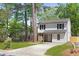 Charming two-story home with stone accents, black shutters and a well-maintained front yard at 6891 Hickory Log Rd, Austell, GA 30168